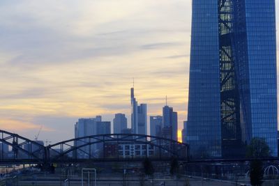 Modern buildings against cloudy sky