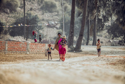 Rear view of people running on land