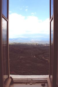 Scenic view of landscape seen through train window