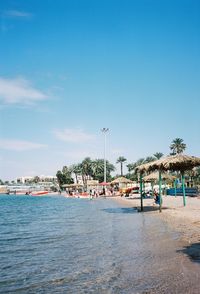 Scenic view of beach against blue sky