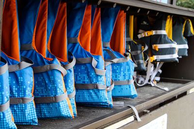 Close-up of safety jackets in row