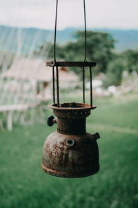 Close-up of metal structure on field against sky