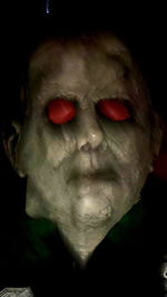 Close-up portrait of man against black background