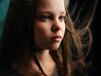 Close-up portrait of young woman looking away