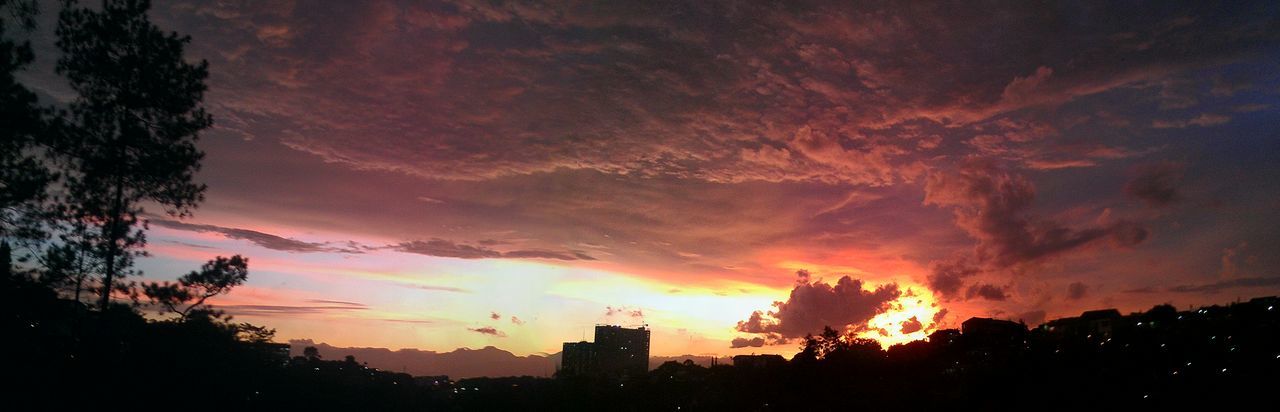 sunset, silhouette, sky, building exterior, orange color, tree, cloud - sky, built structure, architecture, beauty in nature, scenics, dramatic sky, nature, low angle view, tranquil scene, outdoors, idyllic, cloud, tranquility, city