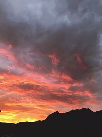 Silhouette mountains against dramatic sky