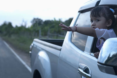 Side view of woman sitting in car