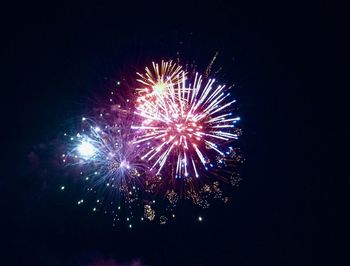 Low angle view of firework display against sky at night