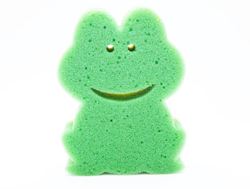 Close-up of green toy over white background