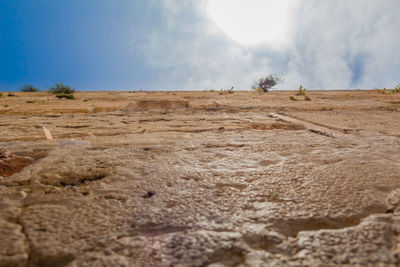 Surface level of desert against sky