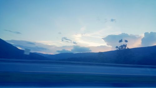 Scenic view of mountains against cloudy sky