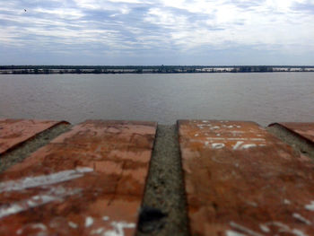 Surface level of calm sea against the sky