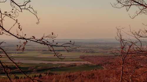 Scenic view of field against sky during sunset