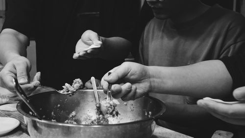 Midsection of man preparing food in kitchen