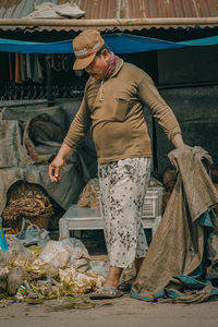 Full length of man standing at market stall