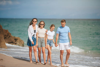 Friends standing at beach