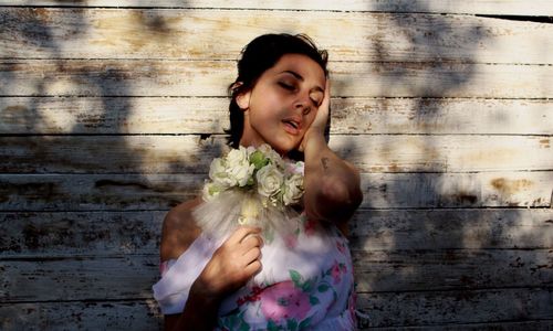 Portrait of young woman with flowers