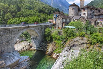 Bridge over river against mountains