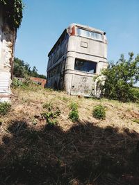 Abandoned building on field against sky