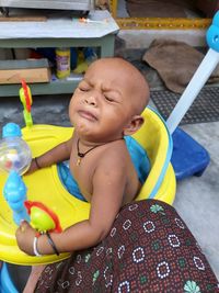 View of crying baby in sitting outdoors