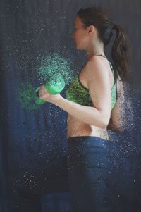 Side view of young woman exercising