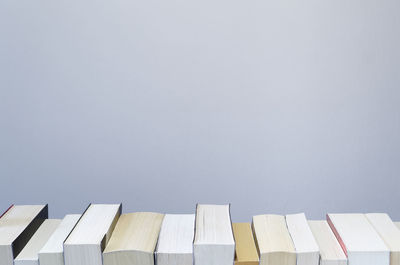White background with books in a row at the bottom