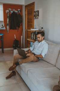 Man sitting on sofa at home