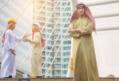 Midsection of woman standing against built structure