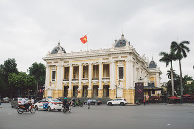 Historic building by street in city