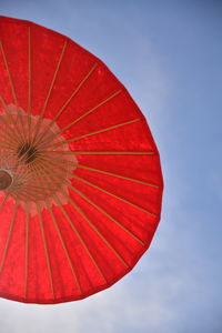 Low angle view of red umbrella against sky