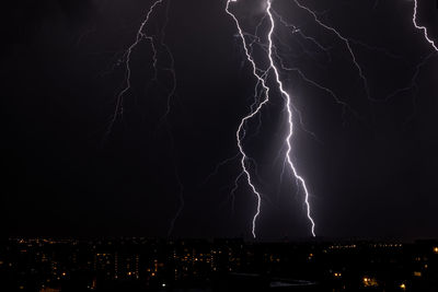 Lighting storm over city at night