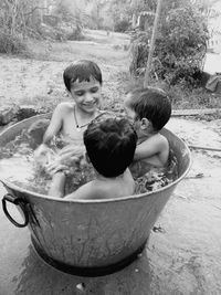 High angle view of boys playing in bathtub