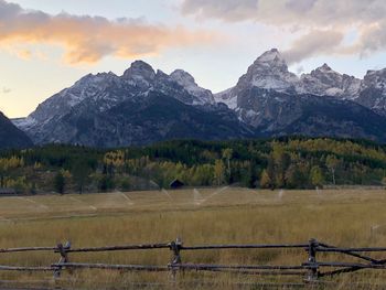 Scenic view of field and mountains against sky