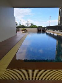 View of swimming pool by building against sky