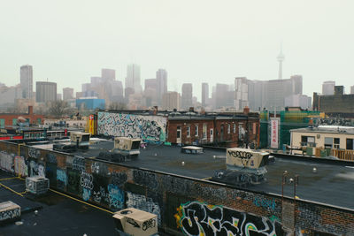 Aerial view of buildings in city against clear sky