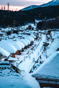 High angle view of snow covered field by mountain