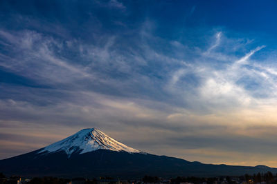 Scenic view of snowcapped mountains against sky during sunset