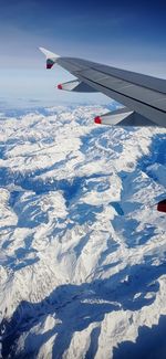 Cropped image of airplane wing against sky