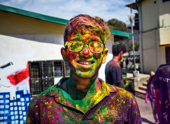 Portrait of man covered with multi colored paint