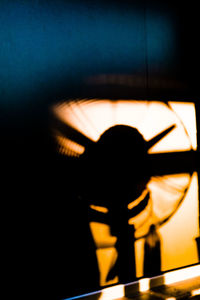 Close-up of silhouette illuminated lamp