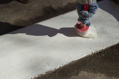 Low section of woman on footpath