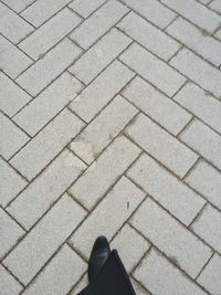 Low section of people standing on tiled floor