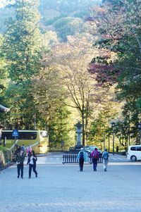 People on road in city against sky