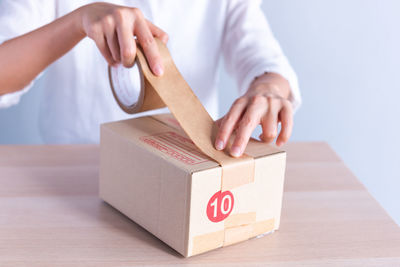 Midsection of man holding gift box