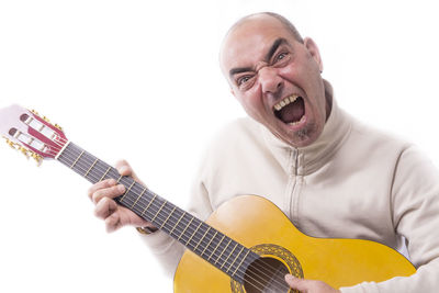 Man playing guitar against white background