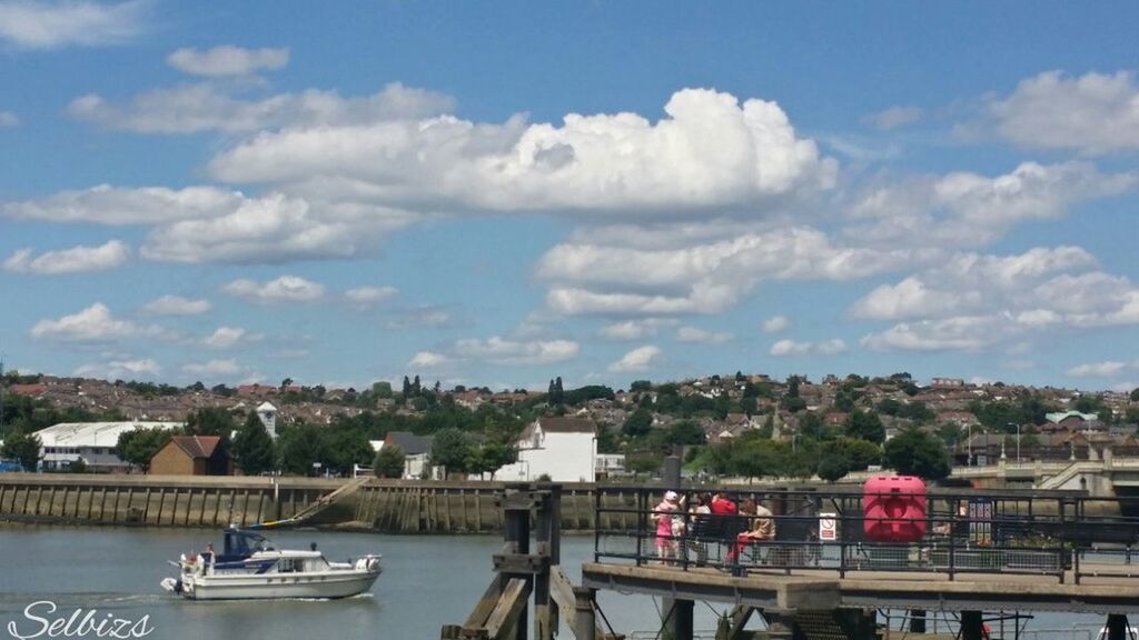 architecture, building exterior, built structure, water, sky, nautical vessel, transportation, river, city, mode of transport, cloud - sky, boat, cityscape, cloud, harbor, day, tree, railing, lake, waterfront