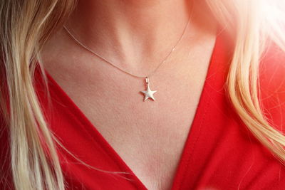 Midsection of woman wearing chain with star shape pendant