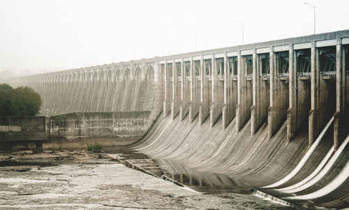 Old dry dam against clear sky