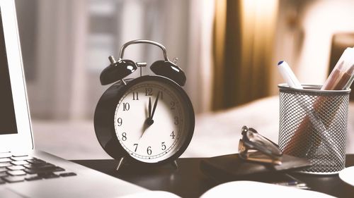 Close-up of clock on table at home