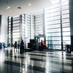 People walking in airport lobby